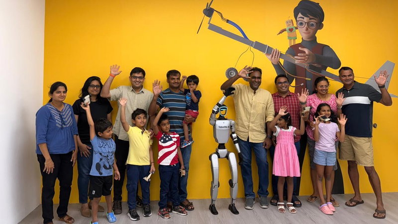 Families and children waving together at the end of a Chitti workshop session