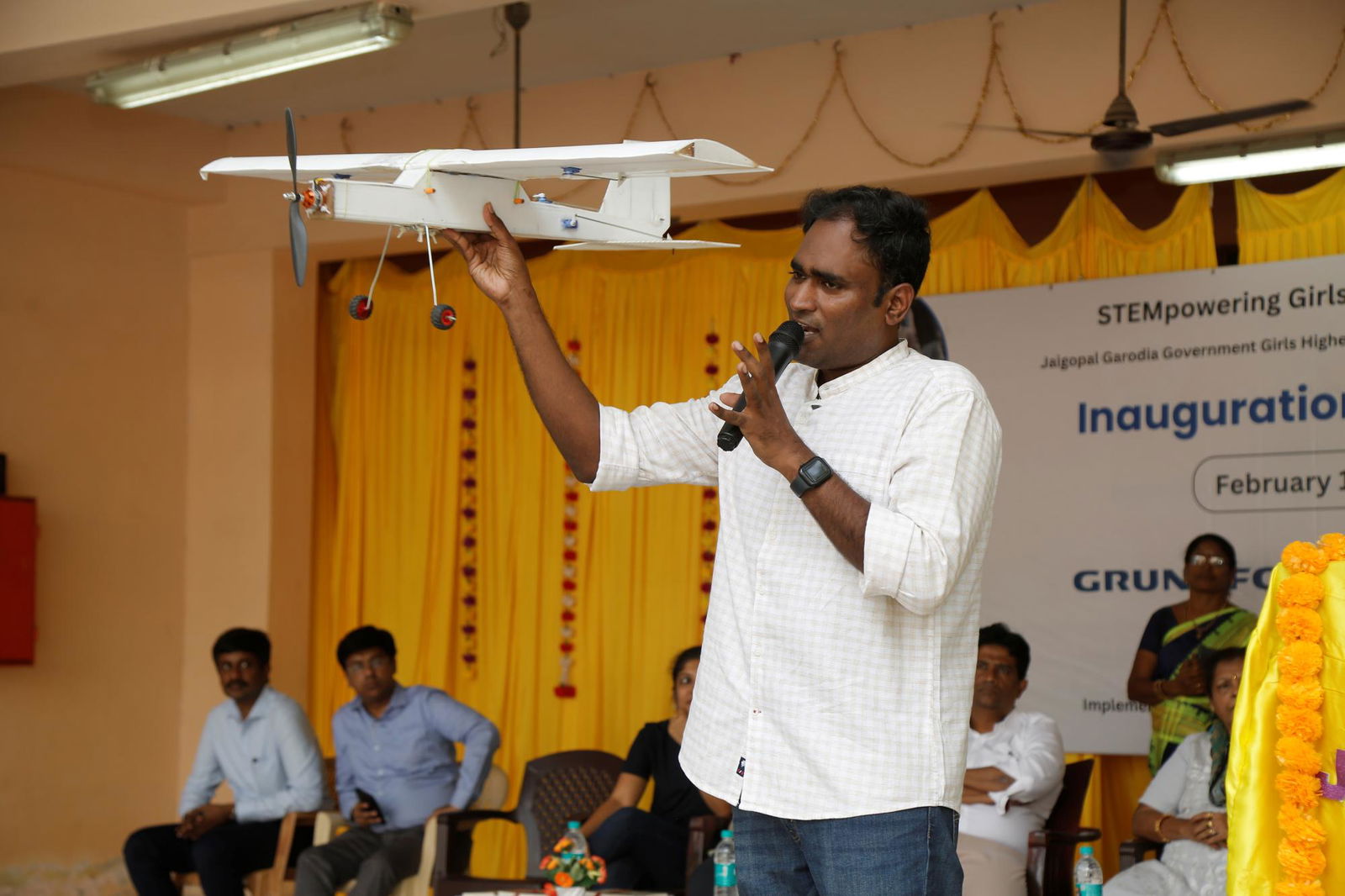 Teacher explaining robotics to students